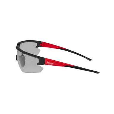 Milwaukee Anti-Scratch Safety Glasses in gray with black frame, angled view showing polycarbonate lens profile and comfortable temple arm.